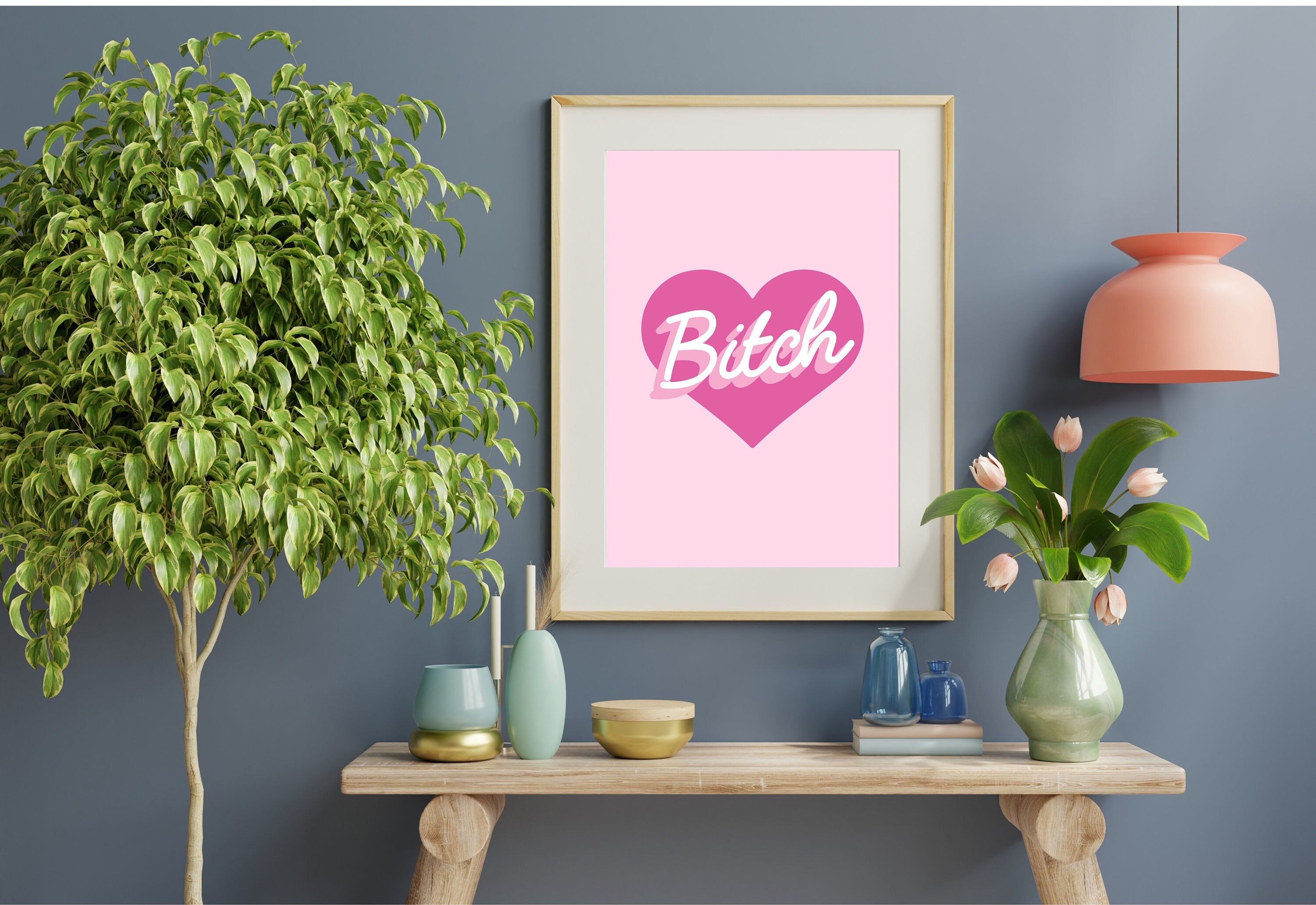 The 'Bitch Heart Light Pink Poster' framed beautifully, ready to enhance your decor.